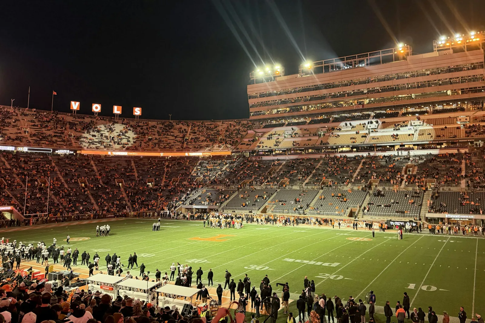 A packed American football stadium under the lights; illustrative image